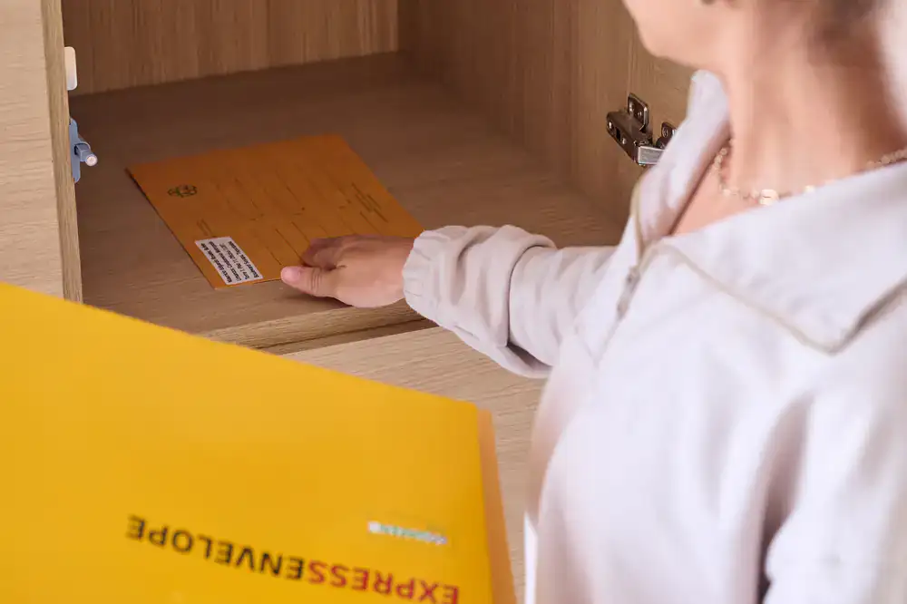 Courier handing a secure document envelope to an office receptionist