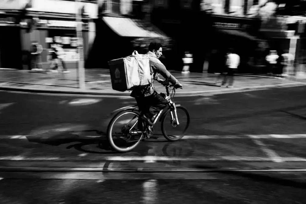 Courier riding rapidly through an urban environment